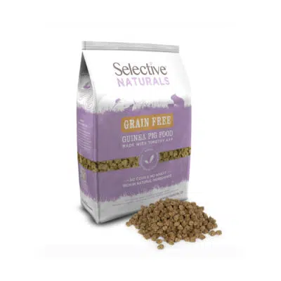 A bag of Selective Naturals Grain Free Guinea Pig Food, made with Timothy hay. The packaging is white and lavender, featuring silhouettes of small animals and key product benefits. In front of the bag, a pile of small, uniform, pellet-shaped guinea pig food is displayed