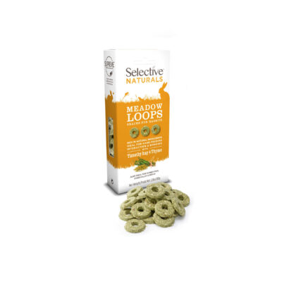 A box of Selective Naturals Meadow Loops, a snack for rabbits and guinea pigs, in Timothy hay and thyme flavor. The packaging is white and orange, featuring silhouettes of small animals and key product benefits. In front of the box, several green, ring-shaped treats are displayed.